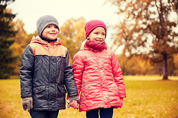 Image showing happy little girl and boy in autumn park