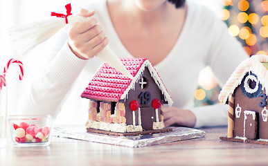 Image showing close up of woman making gingerbread houses