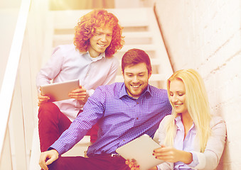 Image showing team with tablet pc computer sitting on staircase