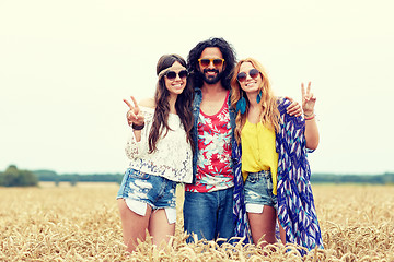 Image showing happy young hippie friends showing peace outdoors