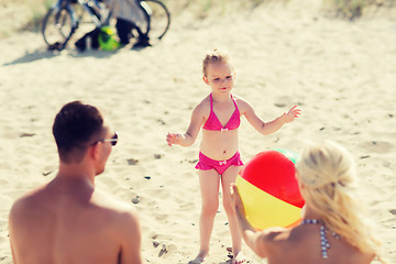 Image showing happy family playing with inflatable ball on beach