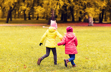 Image showing happy little girls running outdoors