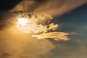 Image showing sunset with sun clouds over clouds