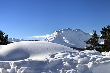 Image showing Snowdrifts in winter mountain after snowfall at sun day