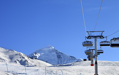 Image showing Ski-lift at ski resort in sun cold morning