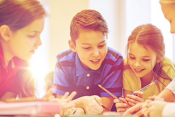 Image showing group of students talking and writing at school