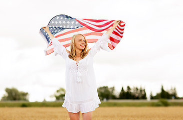 Image showing happy woman with american flag on cereal field