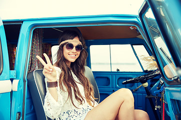 Image showing happy hippie woman showing peace in minivan car