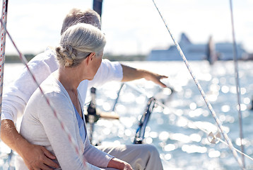 Image showing happy senior couple on sail boat or yacht in sea