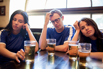 Image showing soccer fans watching football match at bar or pub