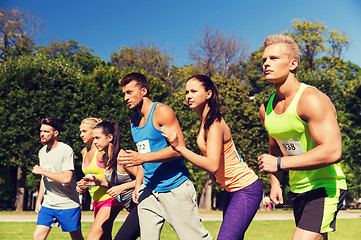 Image showing sportsmen with badge numbers on start of race