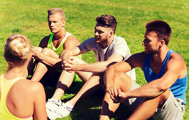 Image showing group of happy friends or sportsmen outdoors