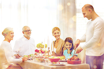 Image showing smiling family having holiday dinner at home