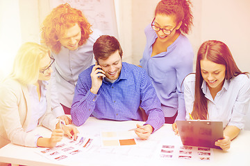 Image showing creative team with papers and clipboard at office