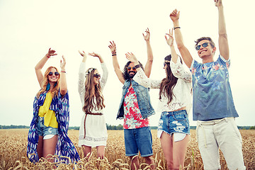 Image showing happy young hippie friends dancing outdoors