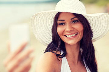 Image showing young woman taking selfie with smartphone