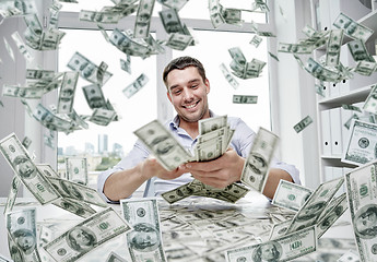 Image showing happy businessman with heap of money