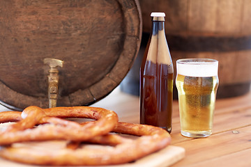 Image showing close up of beer barrel, glass, pretzel and bottle