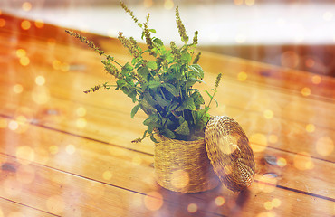 Image showing close up of melissa in basket on wooden table