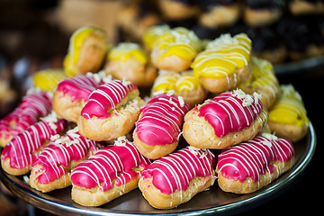 Image showing close up of glazed eclair pile on serving tray