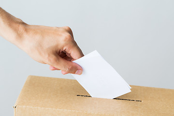 Image showing man putting his vote into ballot box on election