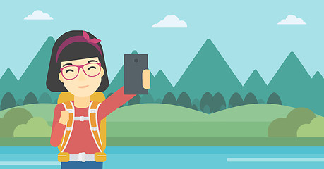 Image showing Woman with backpack making selfie.