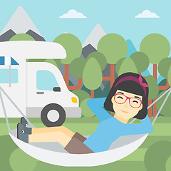 Image showing Woman lying in hammock in front of motor home.