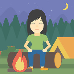 Image showing Woman sitting on log in the camping.