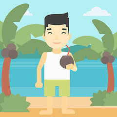 Image showing Man drinking coconut cocktail on the beach.