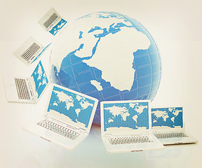 Image showing Laptops around the planet earth . 3D illustration. Vintage style