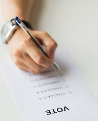 Image showing close up of hands with vote or ballot on election