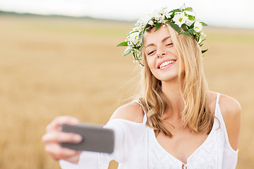 Image showing happy young woman taking selfie by smartphone