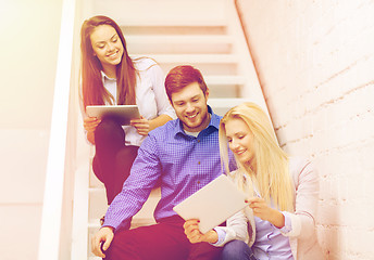 Image showing team with tablet pc computer sitting on staircase