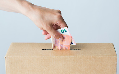 Image showing man putting euro money into donation box