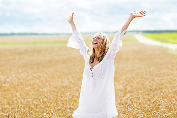 Image showing smiling young woman in white dress on cereal field