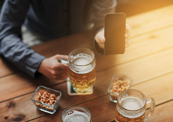 Image showing close up of friends with smartphone and beer