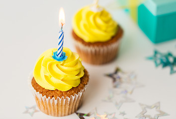 Image showing birthday cupcakes with burning candles