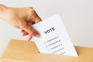 Image showing man putting his vote into ballot box on election