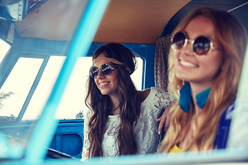 Image showing smiling young hippie women driving minivan car