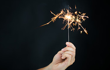 Image showing sparkler burning over black background