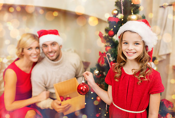 Image showing smiling family decorating christmas tree