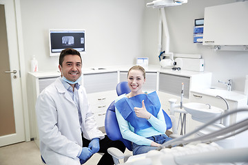 Image showing happy male dentist with woman patient at clinic