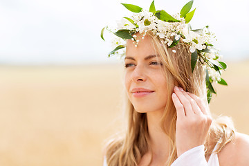 Image showing happy woman in wreath of flowers