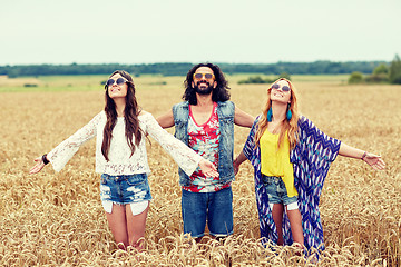 Image showing smiling young hippie friends on cereal field