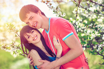 Image showing Young couple enjoying in blooming garden