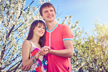 Image showing Young couple enjoying in blooming garden