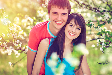 Image showing Young couple enjoying in blooming garden