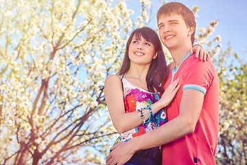 Image showing Young couple enjoying in blooming garden