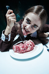 Image showing Bloody Halloween theme: crazy girl with a knife and meat