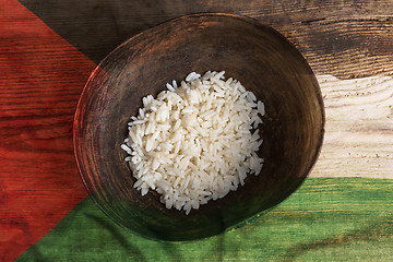 Image showing Poverty concept, bowl of rice with Palestine flag      